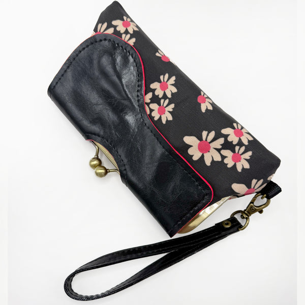 Black Linen Clutch made from custom printed and designed floral textile. Black with hot pink accents. An adjustable cross body strap and wrist strap are included.