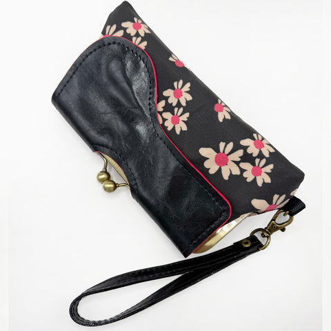 Black Linen Clutch made from custom printed and designed floral textile. Black with hot pink accents. An adjustable cross body strap and wrist strap are included.