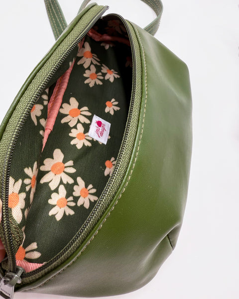 Green bag with floral interior on a white background