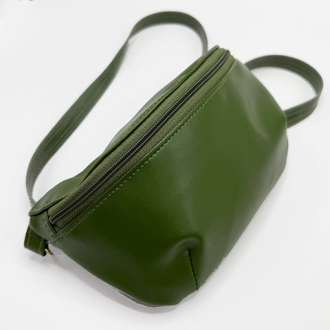 Green leather bag with a strap on a white background