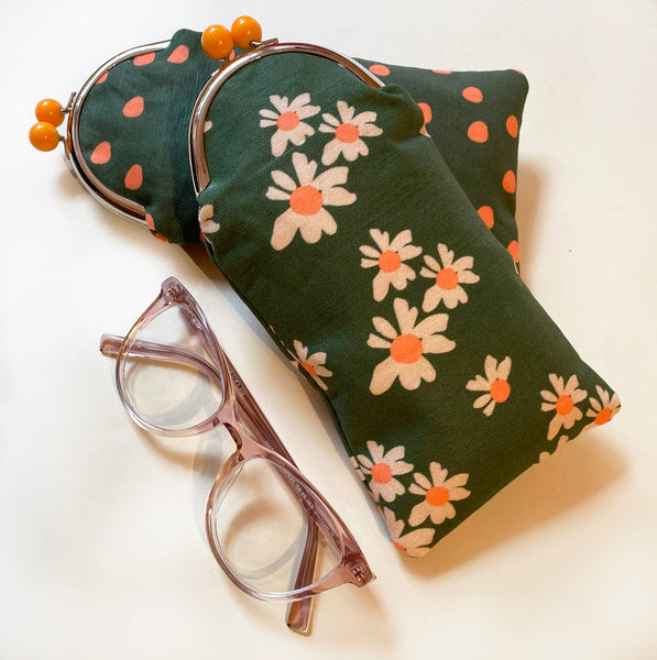 Floral-patterned glasses case with a pair of glasses on a light background