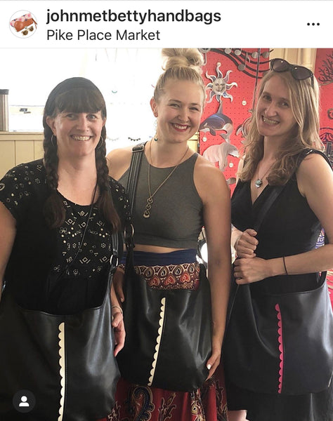 Photo features three women wearing Twyla Cross Body Tote Bags.